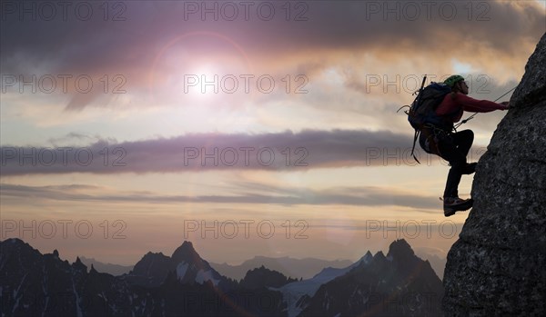 Caucasian climber scaling mountain in remote landscape