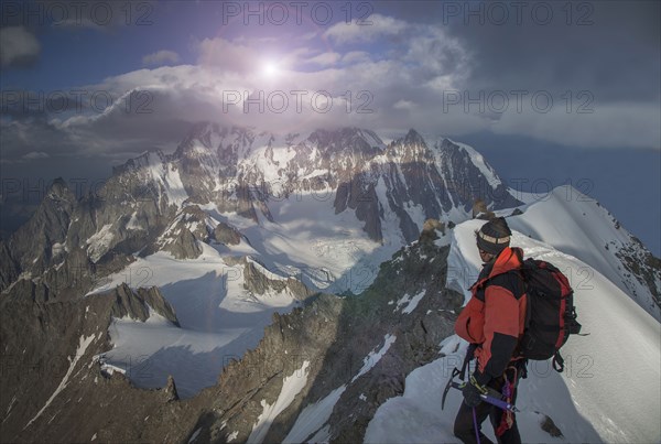 Caucasian climber admiring view from remote mountain top