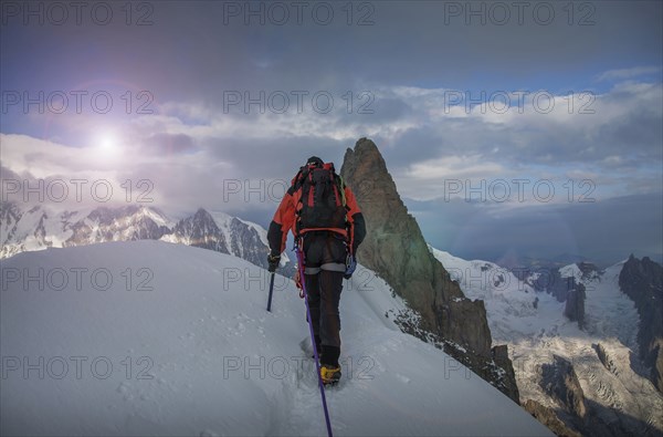 Caucasian climber admiring view from remote mountain top