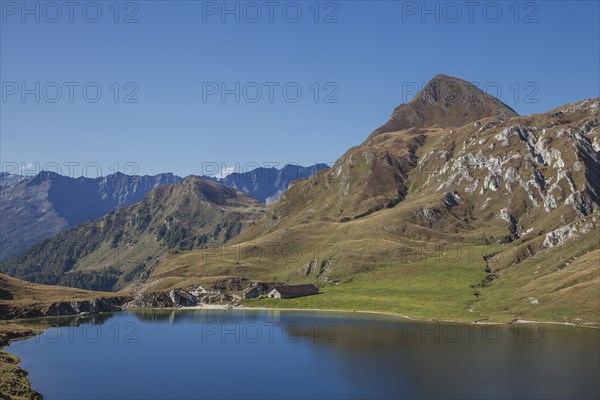 Mountains over still lake in remote landscape