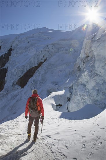 Caucasian hiker standing on snowy mountain