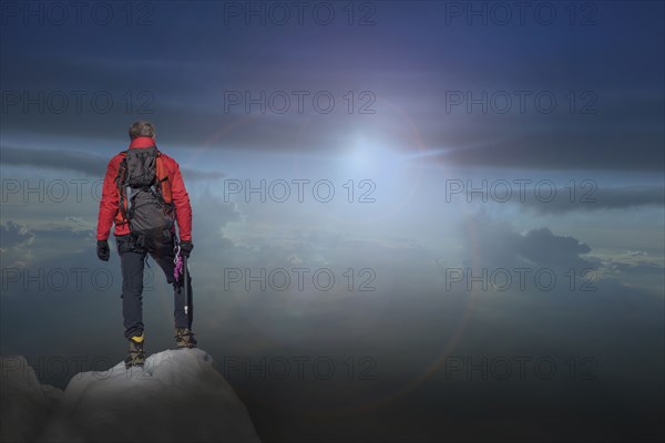 Caucasian hiker standing on mountain top