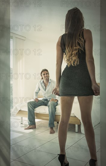 Caucasian couple anticipating passion in bedroom