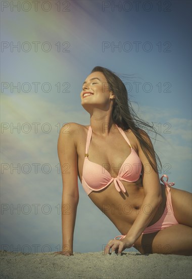 Caucasian woman in pink bikini at beach