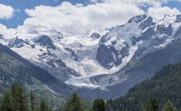 Clouds over snowy mountain range