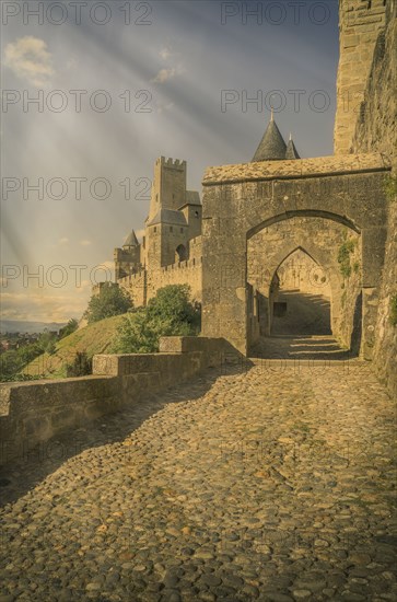 Sunbeams on road to castle in Carcassonne