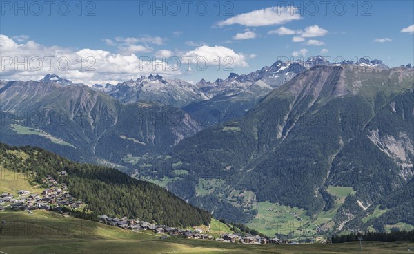 Village in green valley near mountains