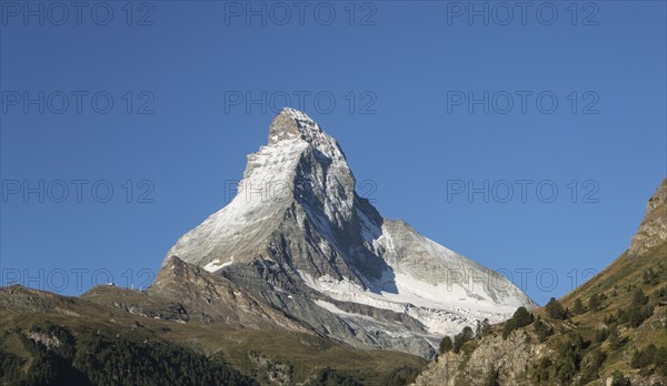 Snow on distant mountain under blue sky