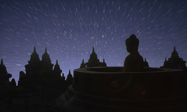 Silhouette of statue of Buddha at sunset