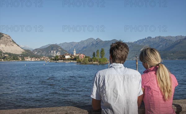 Caucasian couple admiring scenic view of lake