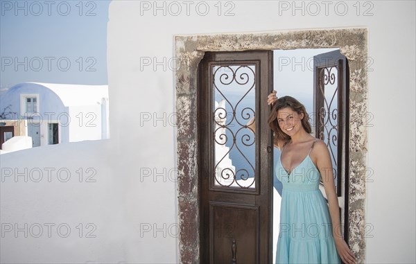 Portrait of smiling Caucasian woman leaning in doorway