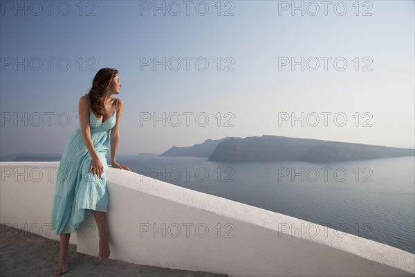 Caucasian woman admiring scenic view of ocean