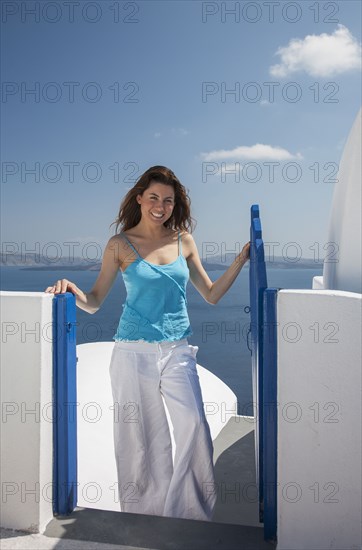 Portrait of Caucasian woman posing near gate at ocean