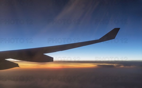 Wing of airplane flying in sky