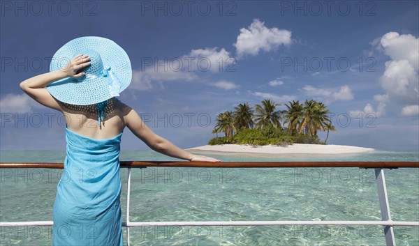 Caucasian woman admiring scenic view of island from boat