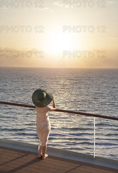 Caucasian woman on boat admiring sunset