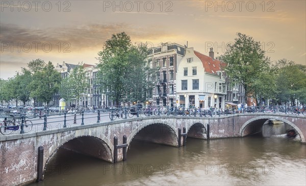 Bicycles on bridge over urban river