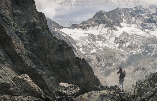 Caucasian man hiking on snowy mountain