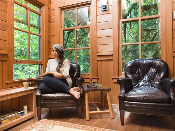 Filipino woman reading in chair