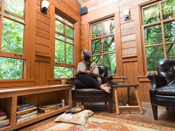 Filipino woman reading in chair