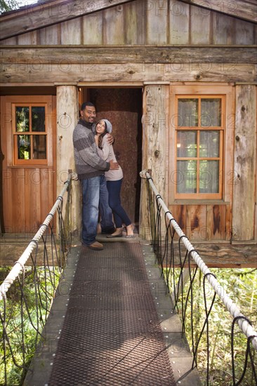 Couple on walkway of remote tree house