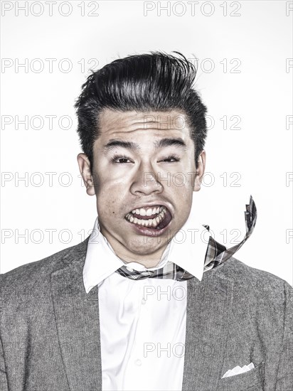 Businessman making face in wind