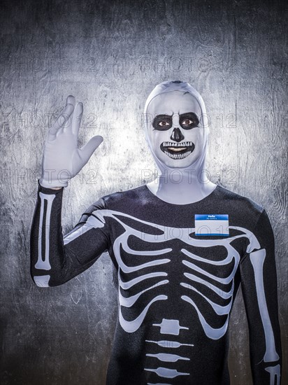 Caucasian man wearing skeleton costume