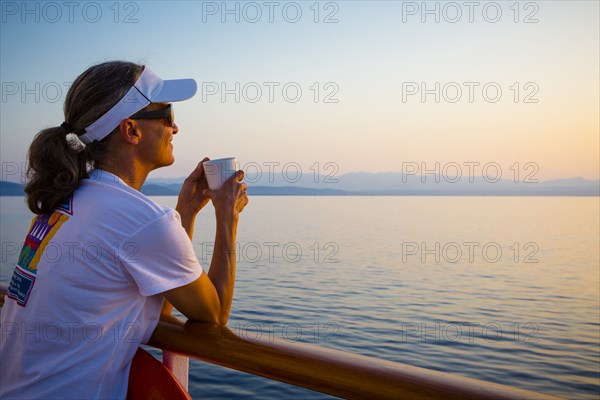 Caucasian woman overlooking ocean from boat deck