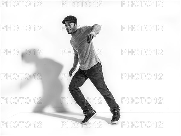 Black dancer casting shadow on wall