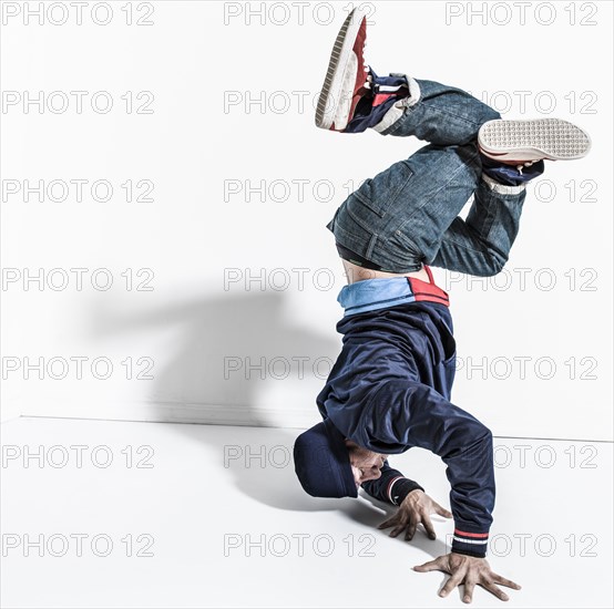 Pacific Islander dancer casting shadows on wall