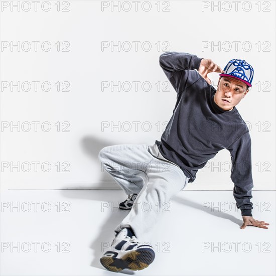 Mixed race dancer casting shadows on wall