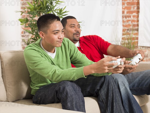 Father and son playing video games together