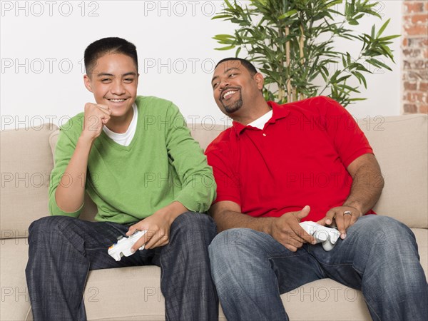 Father and son playing video games together