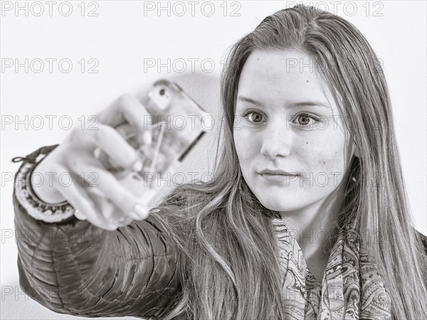 Caucasian teenage girl taking picture with cell phone