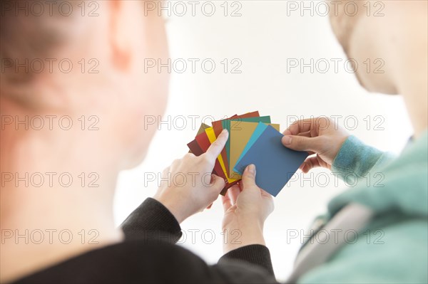 Mixed race couple selecting color swatches