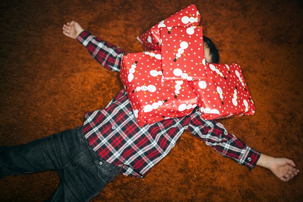 Mixed race boy buried in Christmas gifts