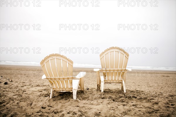 Empty lawn chairs on beach