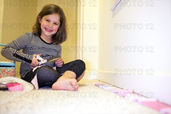 Caucasian girl crafting in playroom