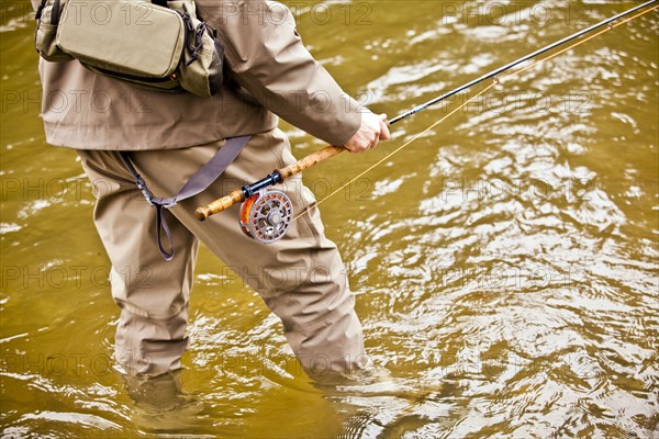 Man fishing in rural river