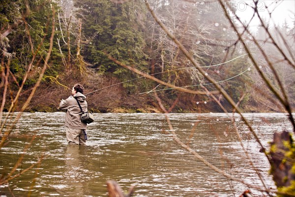 Man fly fishing in rural river