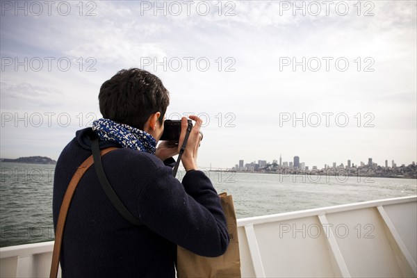 Woman taking picture of city skyline