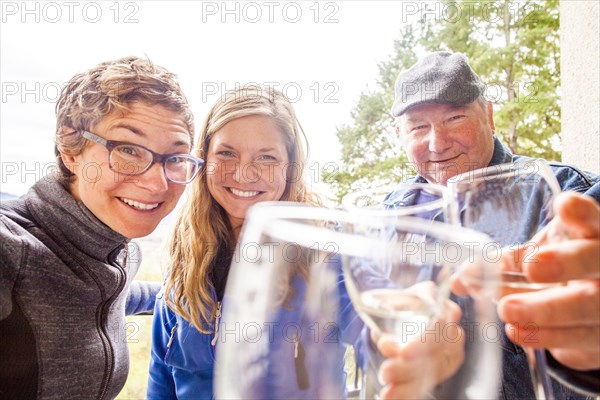 Caucasian family drinking wine together