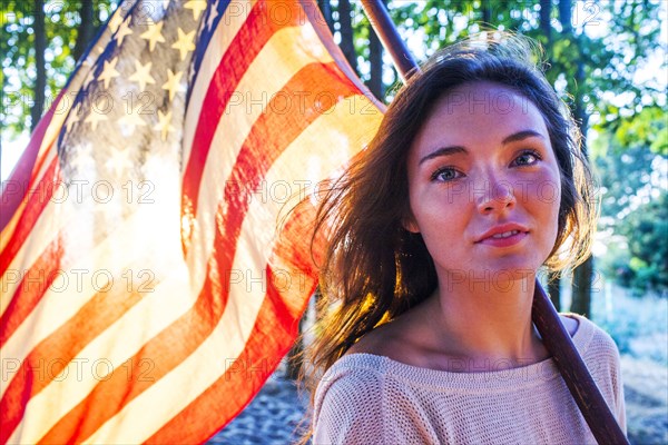 Caucasian woman holding American flag