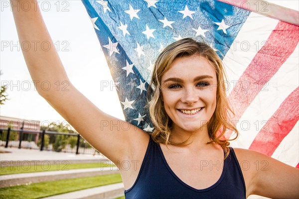 Caucasian teenage girl holding American flag