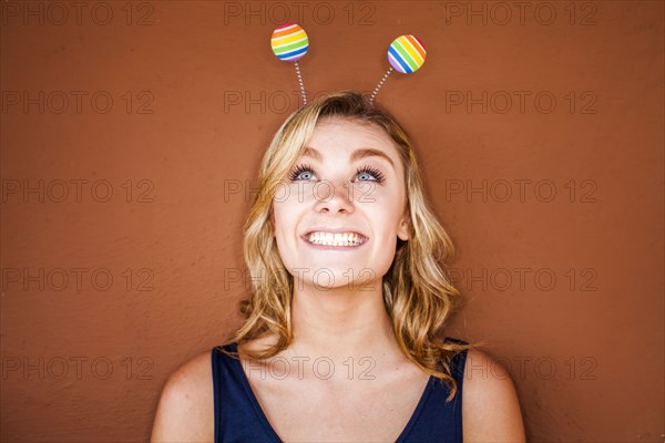 Caucasian teenage girl wearing novelty antenna