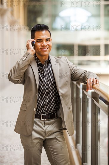 Hispanic businessman talking on cell phone