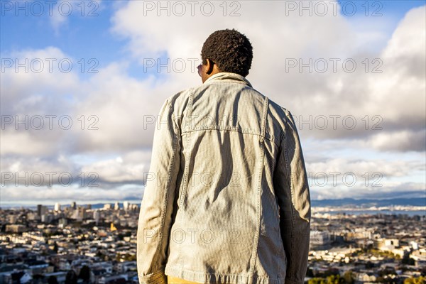 Black man looking at scenic view of cityscape