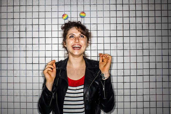 Caucasian woman wearing colorful antenna near wall