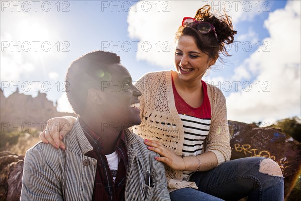 Smiling couple hugging outdoors