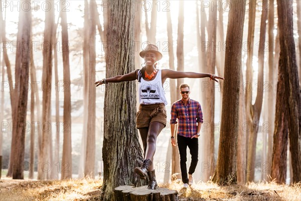 Couple exploring sunny forest